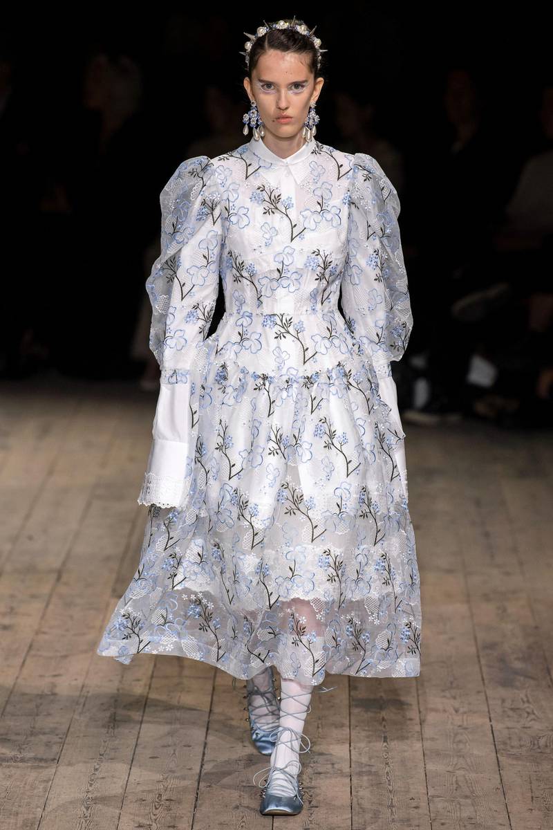 A sheer embroidered dress is worn over a white shirt dress at Simone Rocha spring summer 2020
