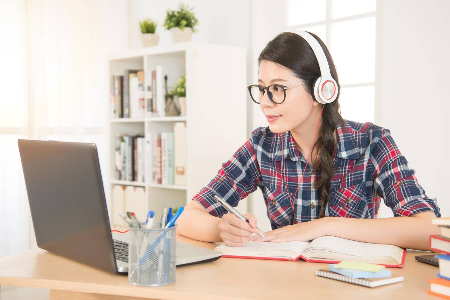 student learning on line with headphones and laptop. mixed race asian chinese model.; Shutterstock ID 549162715; Case Reference: Debi Mauger; Publication Title: B0001 POA Flyer; Division: R & P PQS/Kin Hoang; Project Code: 82054036