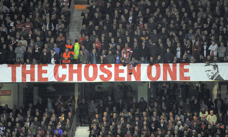 MANCHESTER, ENGLAND - MARCH 19:  Manchester United fans display a David Moyes banner during the UEFA Champions League Round of 16 second round match between Manchester United and Olympiacos FC at Old Trafford on March 19, 2014 in Manchester, England.  (Photo by Laurence Griffiths/Getty Images)