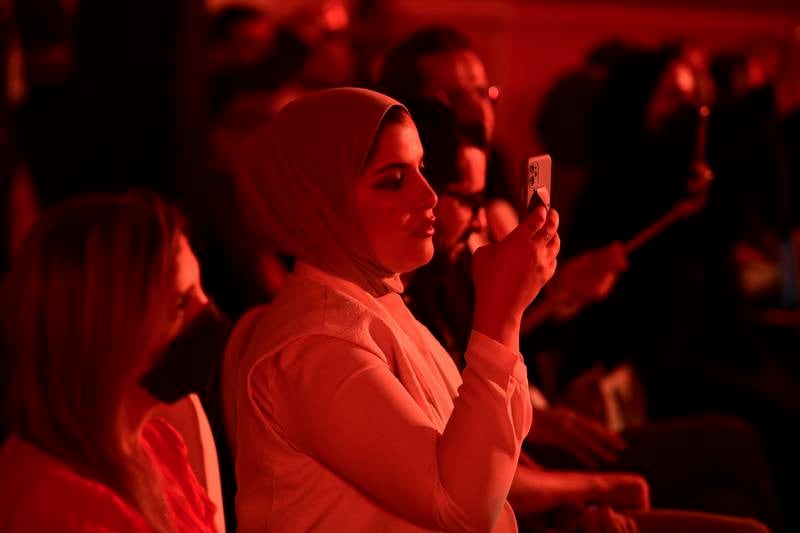 An audience member taking photos at the International Prize for Arabic Fiction awards ceremony.