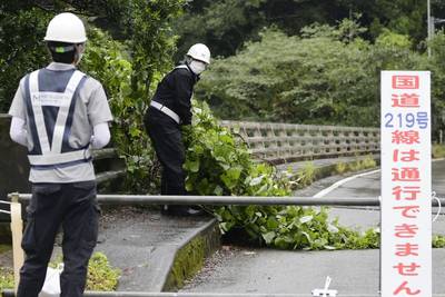 Workers clear debris in Kumamoto, south-western Japan. AP