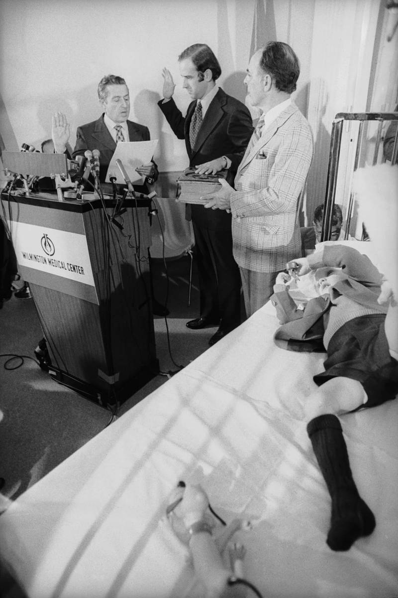 Joe Biden takes his oath of office from US Senate secretary Frank Valeo in son Beau's hospital room with his father-in-law, Robert Hunter, at his side. Bettmann / Getty Images