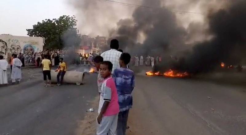 Smoke and fire on the streets of Khartoum as people took the streets after reports of a coup. Reuters