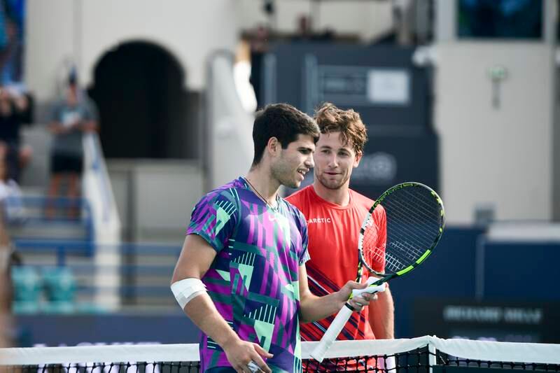 Carlos Alcaraz, left, and Casper Ruud greet each other at the net following their third-place playoff match at the Mubadala World Tennis Championships held in Zayed Sports City, Abu Dhabi. Khushnum Bhandari / The National
