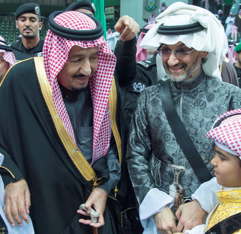 King Salman of Saudi Arabia stands with Saudi Arabian billionaire Prince Alwaleed bin Talal, who was released from detention in late January following the kingdom's crackdown on corruption. The two men are seen talking during the Janadriyah cultural festival in the capital. Bandar Algaloud / Courtesy of Saudi Royal Court / Reuters
