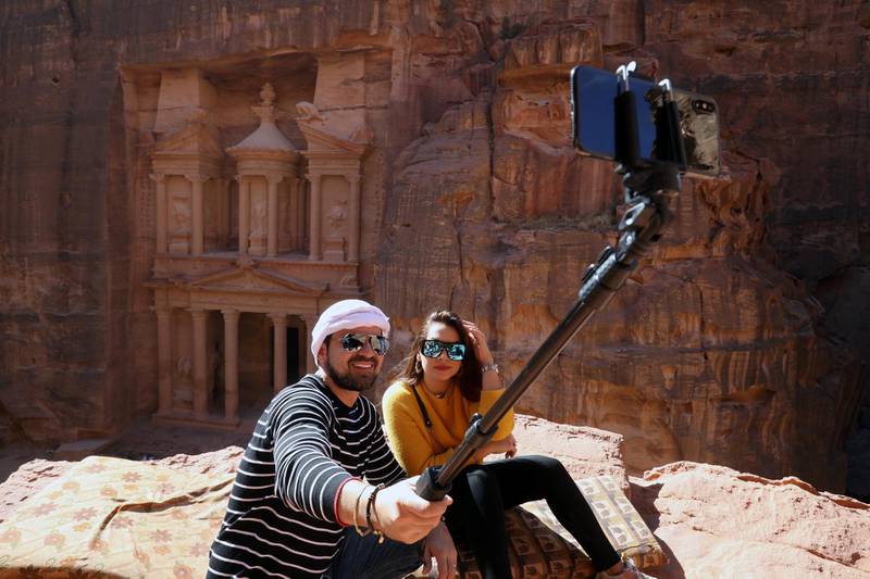 Tourists take selfie pictures in front of the treasury site in the ancient city of Petra, south of Amman, Jordan. Reuters