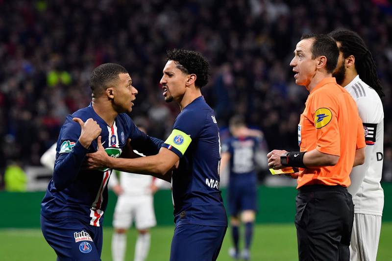 Referee Ruddy Buquet gives a yellow card to Kylian Mbappe. AFP