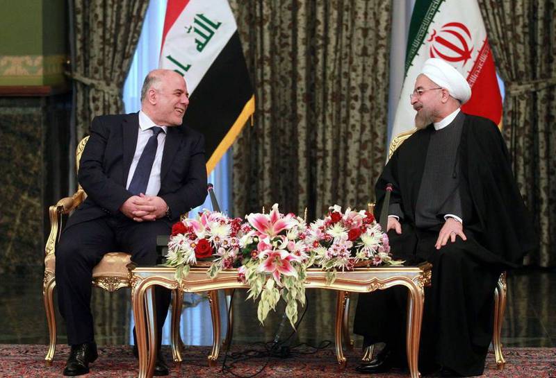 Iran's president, Hassan Rouhani, right with Iraq's prime minister, Haider Al Abadi, in Tehran last year. AFP