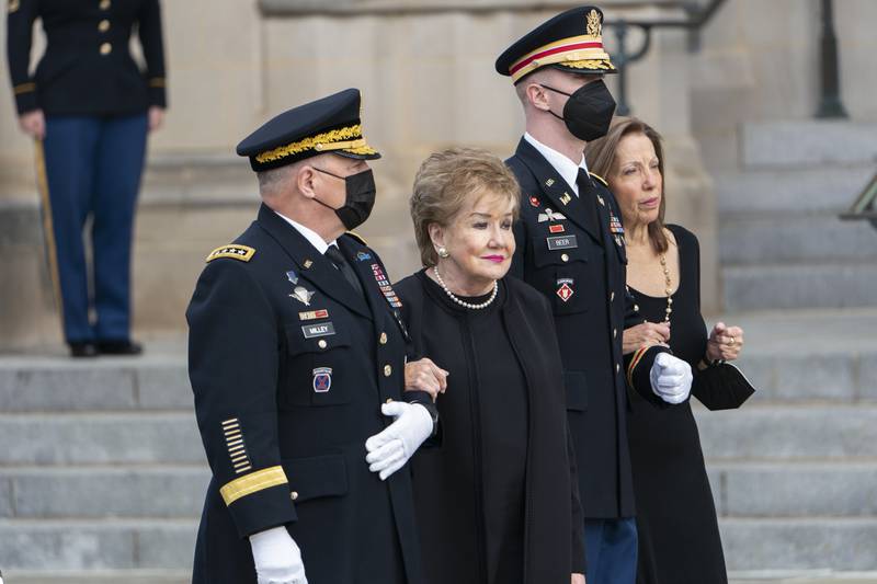 Elizabeth Dole, wife of Bob Dole, accompanied by Chairman of the Joint Chiefs Mark Milley and daughter Robin Dole, watch as his casket is carried into the Washington National Cathedral for a funeral service. AP