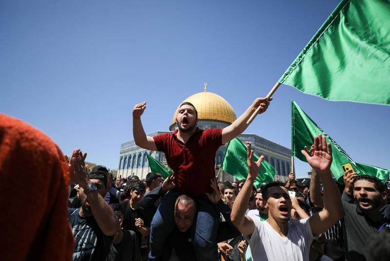 Protesters wave Hamas flags outside Dome of the Rock in east Jerusalem to protest against the planned eviction of Plestinian families in the Sheikh Jarrah neighbourhood of the Old City. Reuters