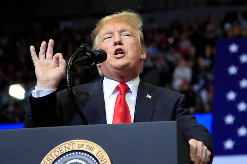 FILE - In this March 28, 2019, file photo, President Donald Trump speaks at a campaign rally in Grand Rapids, Mich. In the campaign for House control, some districts are seeing a fight between Democrats saying they'll protect voters from Republicans willing to take their health coverage away, while GOP candidates are raising specters of rioters imperiling neighborhoods if Democrats win. (AP Photo/Manuel Balce Ceneta, File)