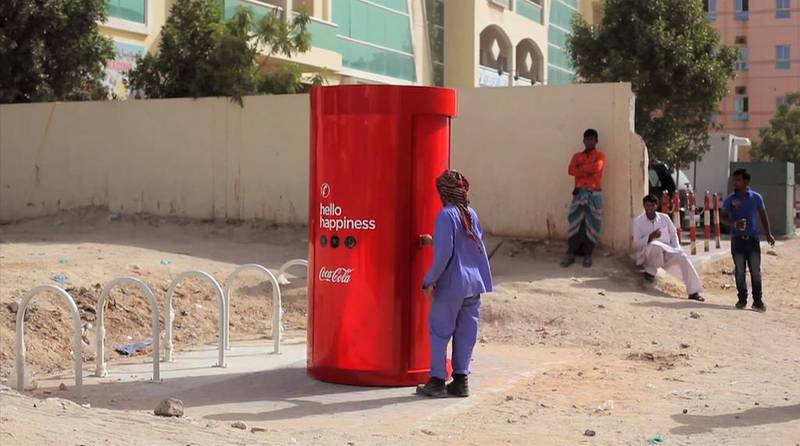A still from Coca-Cola’s “Hello Happiness” video, in which Dubai labour camp residents could make calls to their families at home using Coke bottle caps, which went viral after being posted on YouTube. Courtesy Coca-Cola
