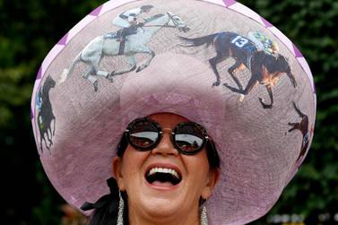 TOPSHOT - A woman poses on day one of the Royal Ascot horse racing meet, in Ascot, west of London, on June 18, 2019. The five-day meeting is one of the highlights of the horse racing calendar. Horse racing has been held at the famous Berkshire course since 1711 and tradition is a hallmark of the meeting. Top hats and tails remain compulsory in parts of the course while a daily procession of horse-drawn carriages brings the Queen to the course. / AFP / Adrian DENNIS