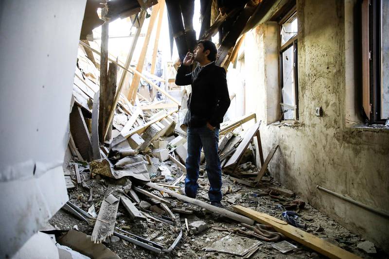 Ali Ibrahimov stands in his damaged home at a blast site hit by a rocket during the fighting over the breakaway region of Nagorno-Karabakh, in the city of Ganja. Reuters