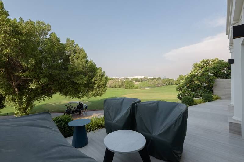 A terrace dining area with golf club views