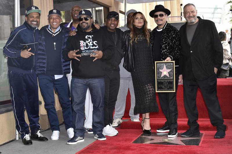 Mike Epps, Russell Simmons, Ice Cube, Chuck D, Hargitay, Ice-T and Dick Wolf pose for photos with Ice-T's new Walk of Fame plaque. AP