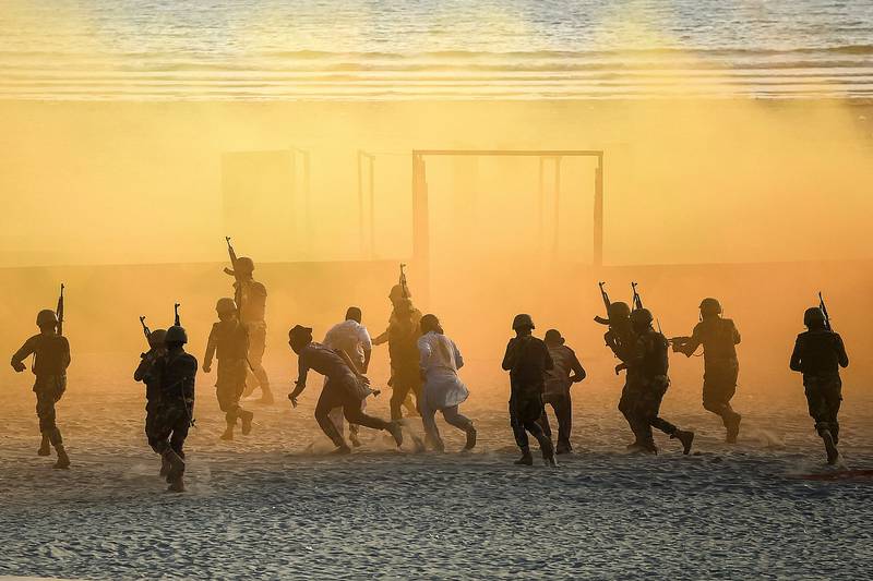Pakistani marines take part in a drill on a beach in Karachi during the 2022 International Defence Exhibition and Seminar. AFP