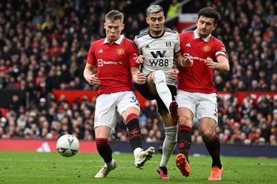 Fulham's Andreas Pereira is sandwiched between Scott McTominay, left, and Harry Maguire of Manchester United. AFP