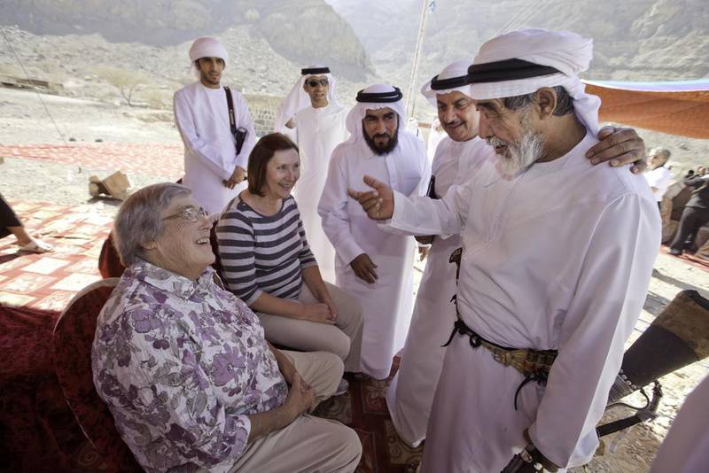 Ruth Ash, left, greets wadi emir Ali Rashed Al Hebsi, accompanied by her niece, Catherine Wilson, in 2013 during a welcoming ceremony for Ash at Wadi Qada’a. Jaime Puebla / The National