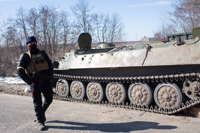 A Ukrainian passes a Russian armoured personnel carrier near Brovary. Getty Images
