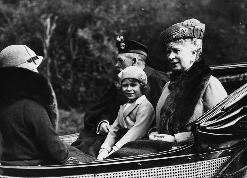 Princess Elizabeth, later Queen Elizabeth II, is seated between her grandfather King George V and grandmother Queen Mary as they ride in a carriage back to Balmoral Castle in Scotland, in August 1935. All photos: Getty Images