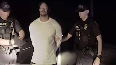 This still image from a dashcam video released by the Jupiter, Florida, Police Department on May 31, 2017, shows Jupiter police offices arresting golfer Tiger Woods on May 29. - The video, from a dashboard camera in the vehicle of Jupiter police officers, shows Woods wobbling as he tries to walk along a straight line in a field sobriety test. Woods has blamed the DUI arrest near his home on an adverse reaction to prescription medication. (Photo by HO / Jupiter Police Department / AFP) / RESTRICTED TO EDITORIAL USE - MANDATORY CREDIT "AFP PHOTO / Jupiter Police Department" - NO MARKETING NO ADVERTISING CAMPAIGNS - DISTRIBUTED AS A SERVICE TO CLIENTS