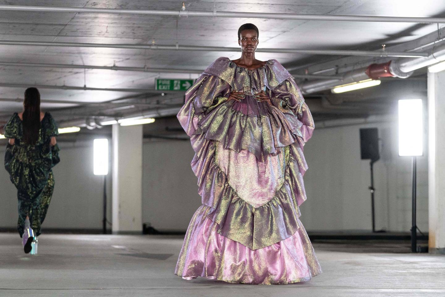 A model walks in a gown made from metallic jacquard for the Edward Crutchley spring/summer 2023 show, which was held in an underground car park. AFP