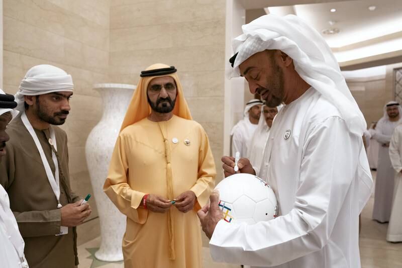 ABU DHABI, UNITED ARAB EMIRATES - March 10, 2019: HH Sheikh Mohamed bin Zayed Al Nahyan, Crown Prince of Abu Dhabi and Deputy Supreme Commander of the UAE Armed Forces (R), signs on a football during the Determination Retreat, at the Presidential Palace. Seen with HH Sheikh Mohamed bin Rashid Al Maktoum, Vice-President, Prime Minister of the UAE, Ruler of Dubai and Minister of Defence (2nd R).

( Ryan Carter for the Ministry of Presidential Affairs)
---