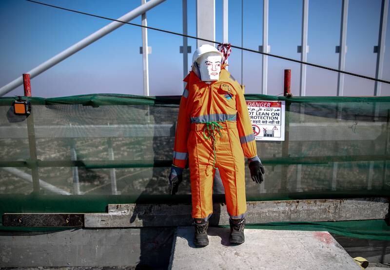 A dummy in full safety gear to remind construction workers at Uptown Tower of on-site safety requirements.