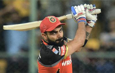 Royal Challengers Bangalore captain and batsman Virat Kohli plays a shot during the 2019 Indian Premier League (IPL) Twenty20 cricket match between Royal Challengers Bangalore and Rajasthan Royals at The M. Chinnaswamy Stadium in Bangalore on April 30, 2019. - The match resumed after the rains stopped and each team will play five overs each. (Photo by Manjunath KIRAN / AFP) / ----IMAGE RESTRICTED TO EDITORIAL USE - STRICTLY NO COMMERCIAL USE----- / GETTYOUT