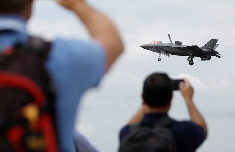 Visitors watch a RAF F-35 aircraft at the Farnborough International Airshow in Hampshire, southern England. Reuters