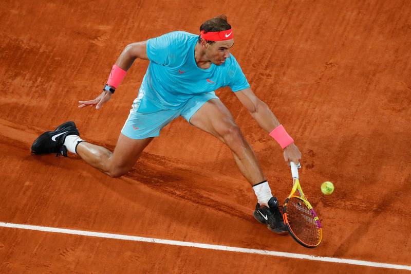 Spain's Rafael Nadal slides to play a shot against Serbia's Novak Djokovic. AP