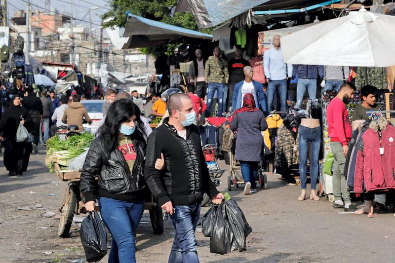 Lebanese, some wearing protective masks due to the COVID-19 pandemic, shop at a market in the Sabra neighbourhood of Beirut on January 6, 2020. The Lebanese government announced tightened restrictions through January in a bid to contain a spike in novel coronavirus infections threatening to overwhelm its health infrastructure. The authorities had eased measures in December but scenes of revellers thronging bars and clubs during the holiday season had left little doubt that fresh restrictions were on the way.
 / AFP / ANWAR AMRO
