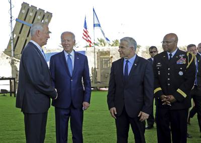 Israeli Defence Minister Benny Gantz, left, US President Joe Biden, second left, caretaker Prime Minister Yair Lapid, right, and Brig Gen Shawn Harris, defence attache to the US embassy, in front of Israel's Iron Dome defence system during a tour at Ben Gurion Airport. AP