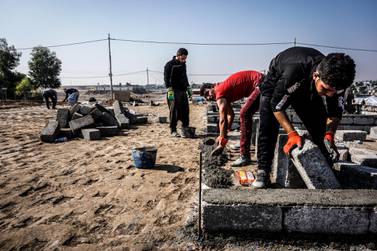 Iraqi-Kurdish labourers lay concrete bases for fresh rows of tents at Gawilan camp before new residents and the winter months arrive, November 1, 2019. Jack Moore / The National