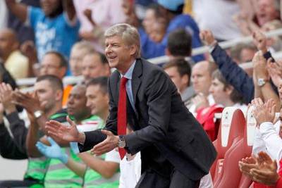 Arsenal manager Arsene Wenger celebrates after Alex Song (unseen) scored their third goal during their English Premier League soccer match against Bolton Wanderers at the Emirates Stadium in London September 24, 2011.    REUTERS/Eddie Keogh (BRITAIN - Tags: SPORT SOCCER) FOR EDITORIAL USE ONLY. NOT FOR SALE FOR MARKETING OR ADVERTISING CAMPAIGNS. NO USE WITH UNAUTHORIZED AUDIO, VIDEO, DATA, FIXTURE LISTS, CLUB/LEAGUE LOGOS OR "LIVE" SERVICES. ONLINE IN-MATCH USE LIMITED TO 45 IMAGES, NO VIDEO EMULATION. NO USE IN BETTING, GAMES OR SINGLE CLUB/LEAGUE/PLAYER PUBLICATIONS