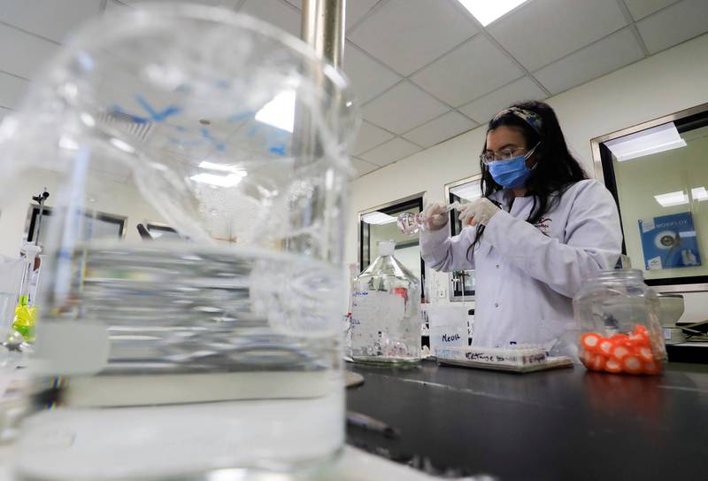 FILE PHOTO: A pharmacist doctor works on the basics of the raw materials for investigational of the coronavirus disease (COVID-19) treatment drug "Remdesivir", in Ibn Sina laboratory, at Eva Pharma Facility in Cairo, Egypt June 25, 2020. REUTERS/Amr Abdallah Dalsh -/File Photo