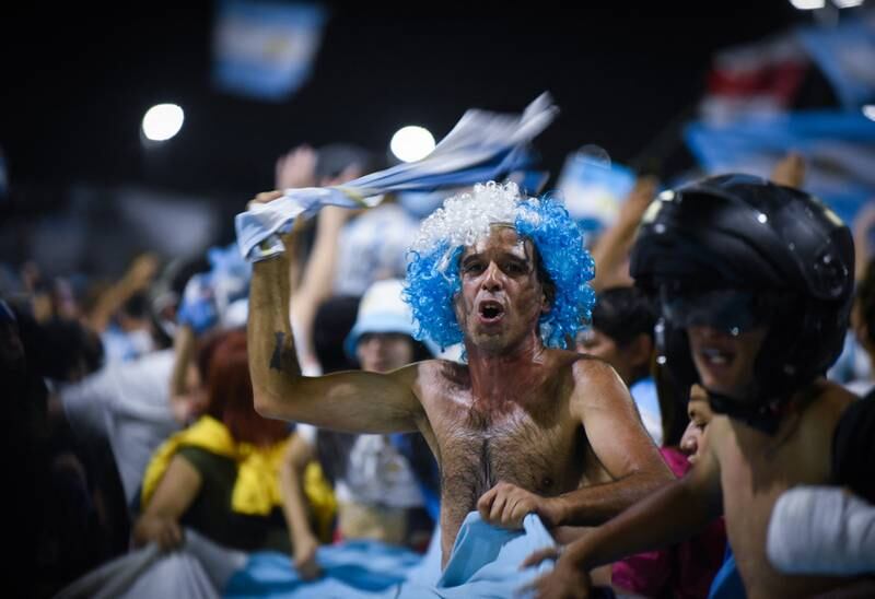 Fans gather outside the Argentinian Football Association headquarters ahead of the team bus arrival. Reuters