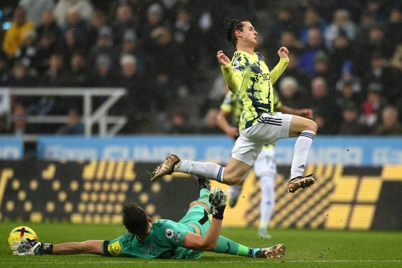 Newcastle goalkeeper Nick Pope slides in to save from Brenden Aaronson of Leeds. Getty
