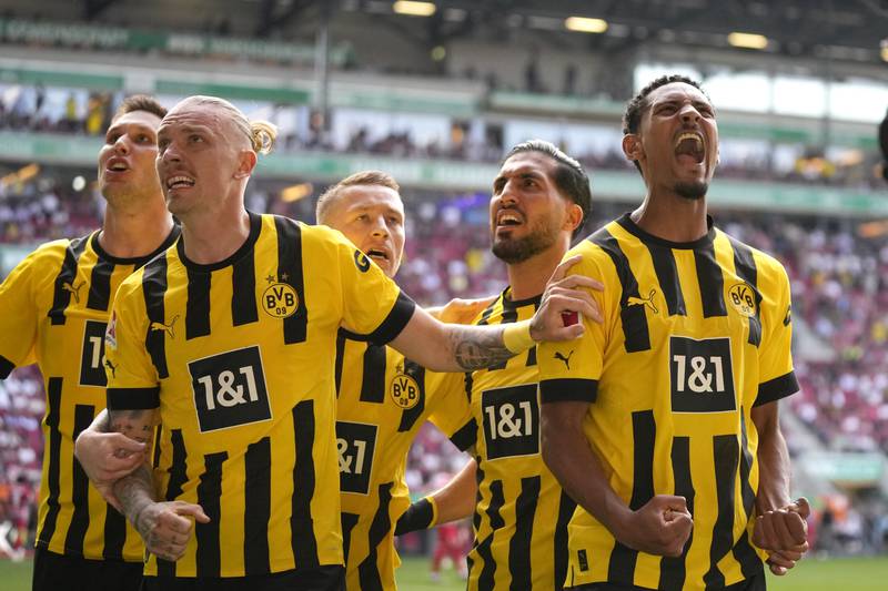Borussia Dortmund players celebrate after Dortmund's Sebastien Haller, right, scored his side's second goal. AP Photo