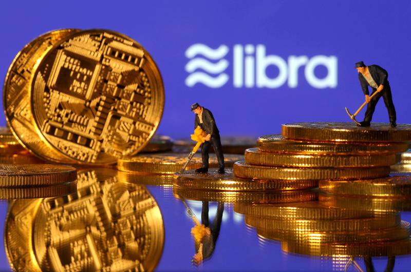 FILE PHOTO: FILE PHOTO: Small toy figures are seen on representations of virtual currency in front of the Libra logo in this illustration picture, June 21, 2019. REUTERS/Dado Ruvic/File Photo