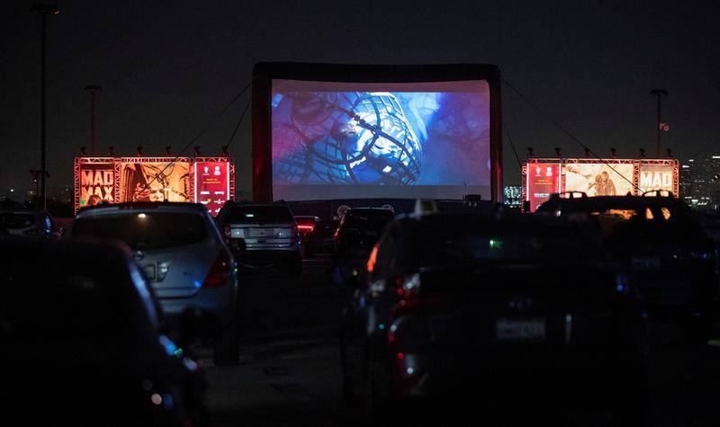 Guests watch a screening of "Mad Max: Fury Road" to benefit the Charlize Theron Africa Outreach Project at a rooftop drive-in during the outbreak of the coronavirus disease (COVID-19), in Los Angeles, California, U.S., July 31, 2020. REUTERS/Mario Anzuoni