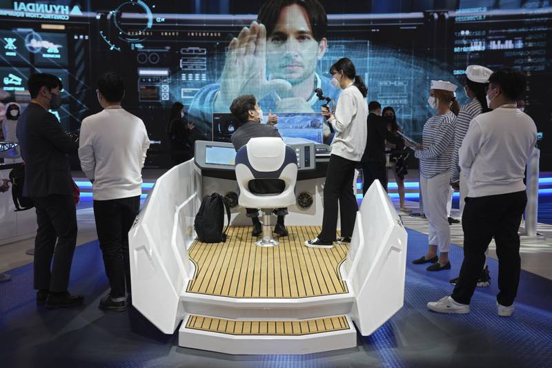 Attendees try out autonomous boat technology at the Hyundai Heavy Industries Group stand at CES 2022. AP Photo
