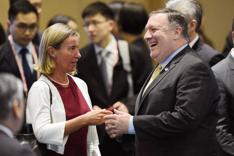 U.S. Secretary of State Mike Pompeo , right, speaks to European Union's Foreign Policy Chief Federica Mogherini ahead of the at the 25th ASEAN Regional Forum Retreat in Singapore, Saturday, Aug. 4, 2018. (AP Photo/Joseph Nair)