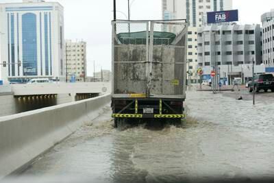 Vehicles on a waterlogged road in the city. Khushnum Bhandari / The National