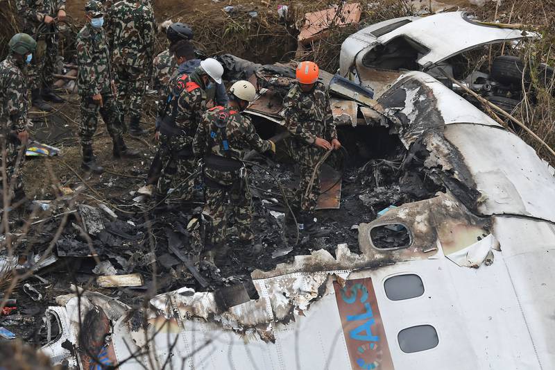 Rescuers inspect the wreckage at the site of a Yeti Airlines plane crash in Pokhara. AFP