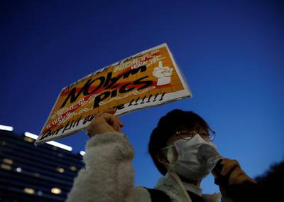 A protester holds a banner in front of the National Stadium. Reuters