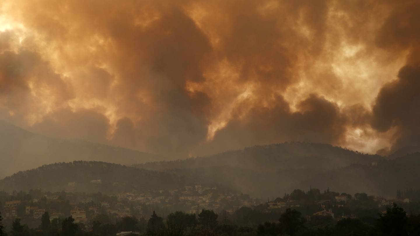 Smoke spreads over Parnitha mountain during a wildfire in the village of Ippokratios Politia, Greece.