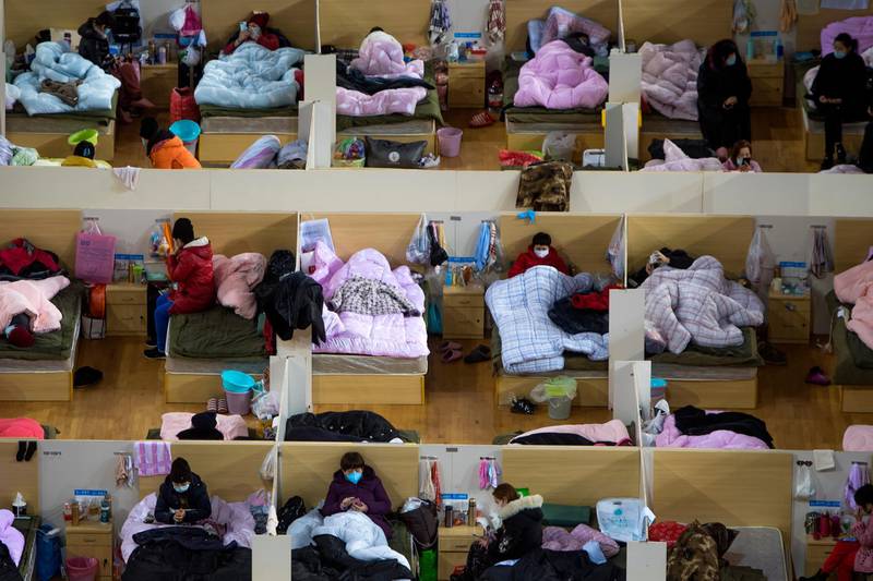 Patients infected with the coronavirus take rest at a temporary hospital converted from Wuhan Sports Center in Wuhan in central China's Hubei Province.  AP