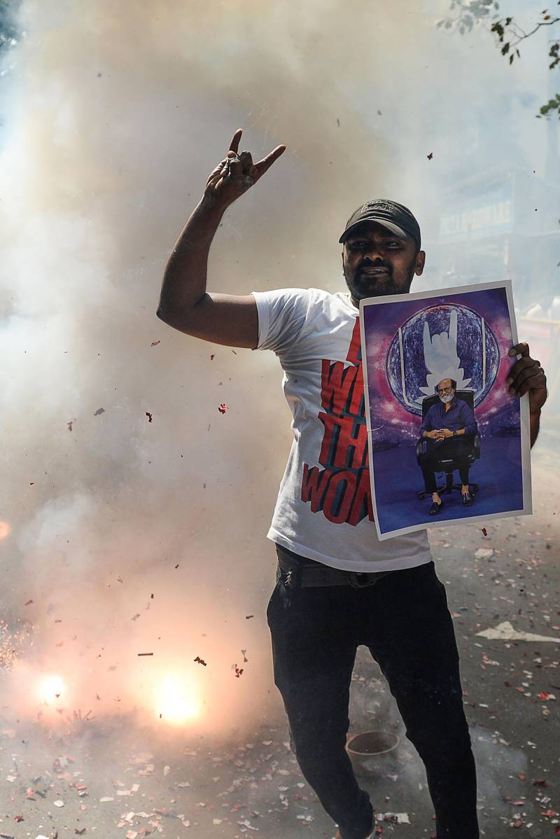 An Indian fan of Rajinikanth celebrates after his announcement. Arun Sankar / AFP